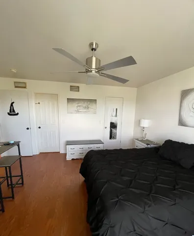 a bedroom with a bed and a lamp on table