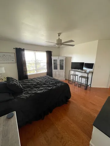 a view of a livingroom with furniture window and wooden floor