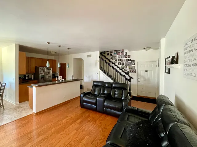 a living room with furniture and wooden floor