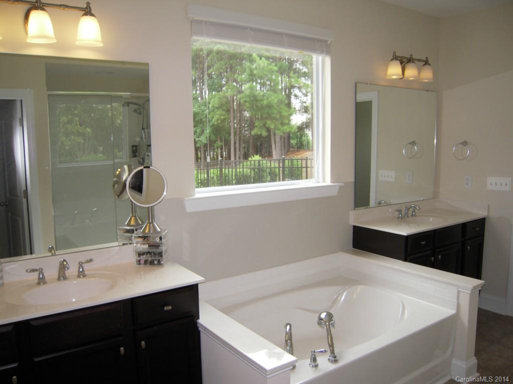 416 Nugget Court, Unit 39 Fort Mill, SC 29708 - Photo 11 of 24 a bathroom with a tub sink and mirror