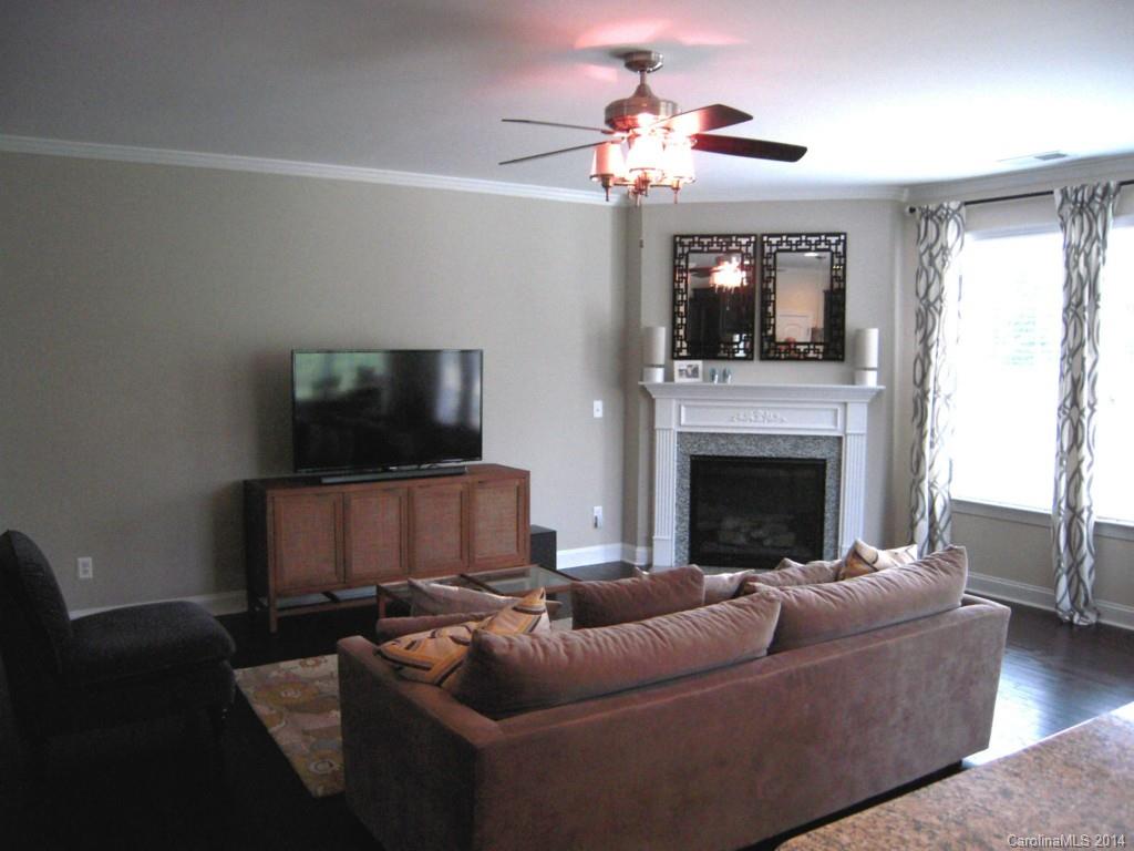 416 Nugget Court, Unit 39 Fort Mill, SC 29708 - Photo 3 of 24 a living room with furniture a flat screen tv and a fireplace