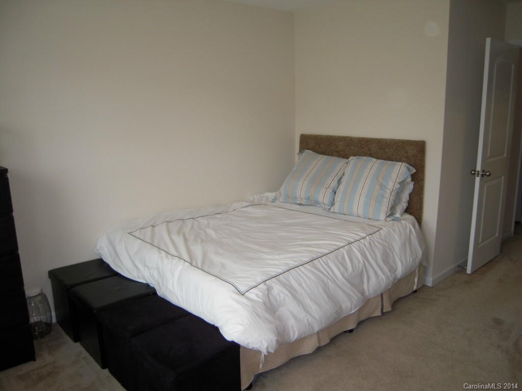 416 Nugget Court, Unit 39 Fort Mill, SC 29708 - Photo 22 of 24 a bed sitting in a bedroom next to a window with kitchen