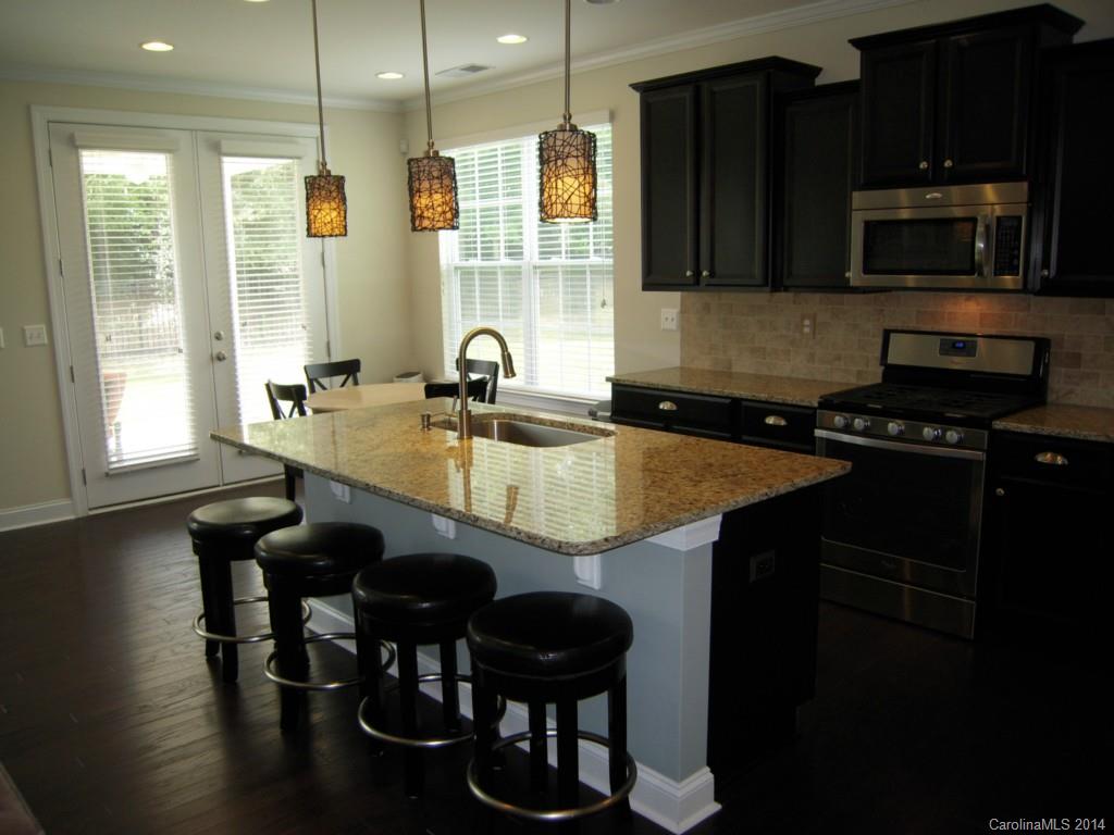 416 Nugget Court, Unit 39 Fort Mill, SC 29708 - Photo 4 of 24 a kitchen with a table chairs sink and cabinets