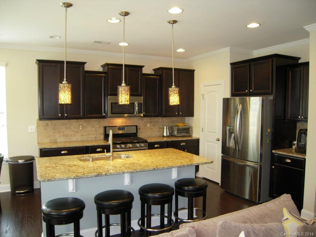 416 Nugget Court, Unit 39 Fort Mill, SC 29708 - Photo 5 of 24 a kitchen with refrigerator and chairs