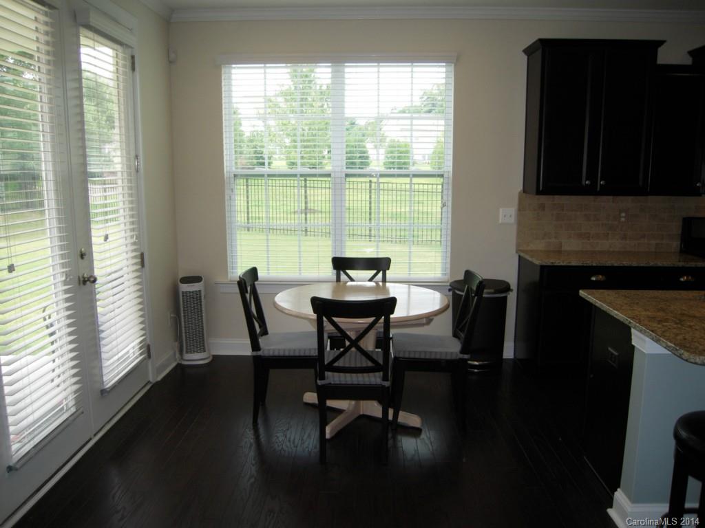 416 Nugget Court, Unit 39 Fort Mill, SC 29708 - Photo 6 of 24 a dining room with furniture and wooden floor