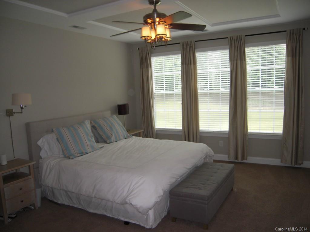 416 Nugget Court, Unit 39 Fort Mill, SC 29708 - Photo 10 of 24 a bedroom with a large bed and a chandelier