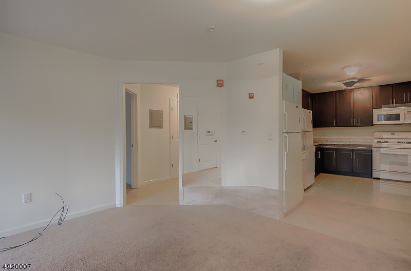 2889 Highway 10, Unit 2301 Morris Plains, NJ 07950 - Photo 2 of 16 a view of a kitchen with a sink cabinets and a refrigerator