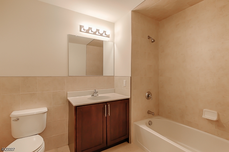 2889 Highway 10, Unit 2301 Morris Plains, NJ 07950 - Photo 5 of 16 a bathroom with a sink a toilet and shower