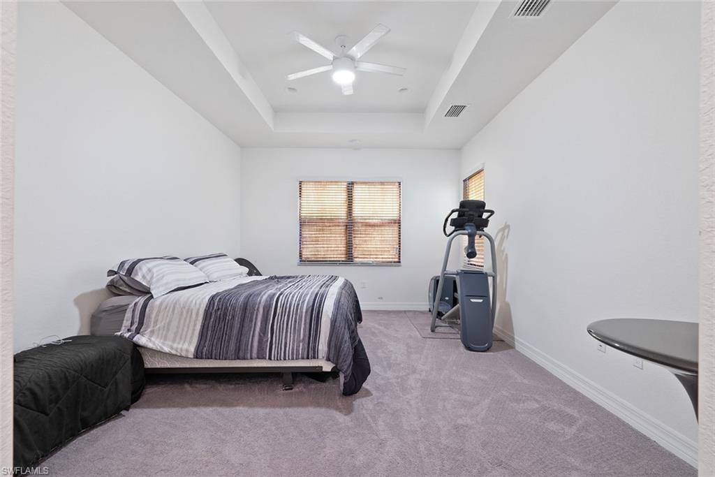 13750 Callisto Avenue Naples, FL 34109 - Photo 11 of 46 a bedroom with a bed and a table