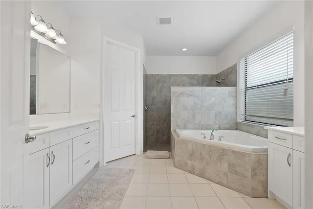 a bathroom with a bathtub and a sink
