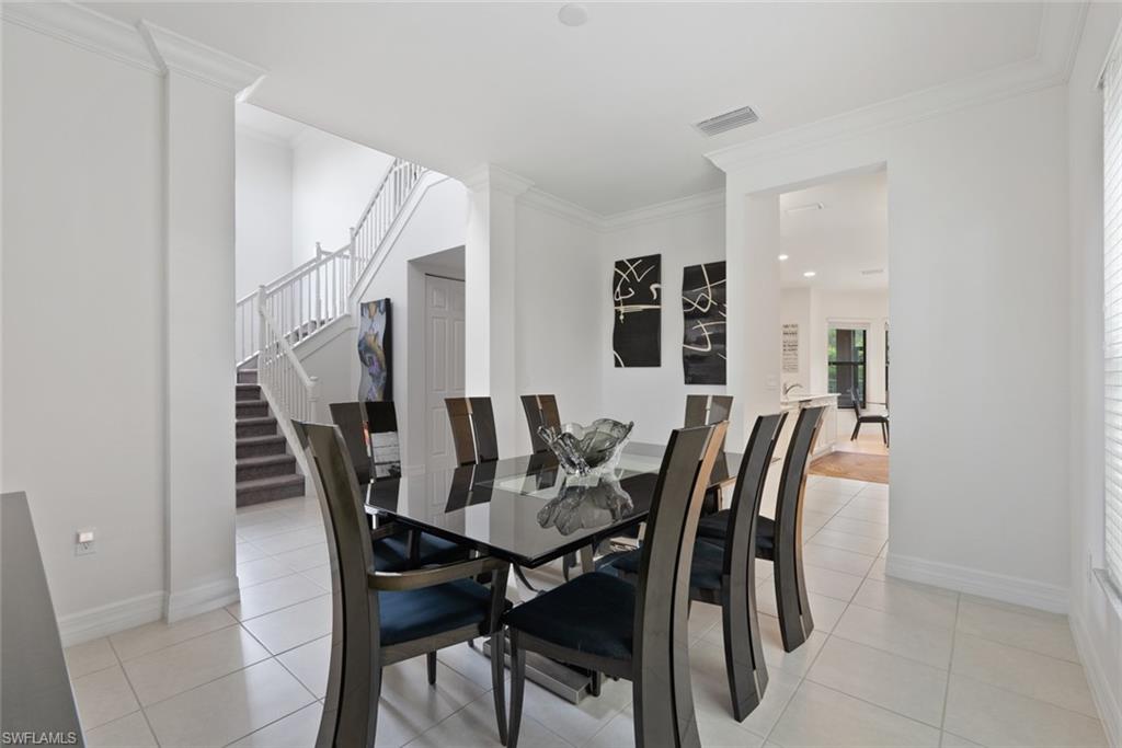 13750 Callisto Avenue Naples, FL 34109 - Photo 14 of 46 a view of a dining room with furniture