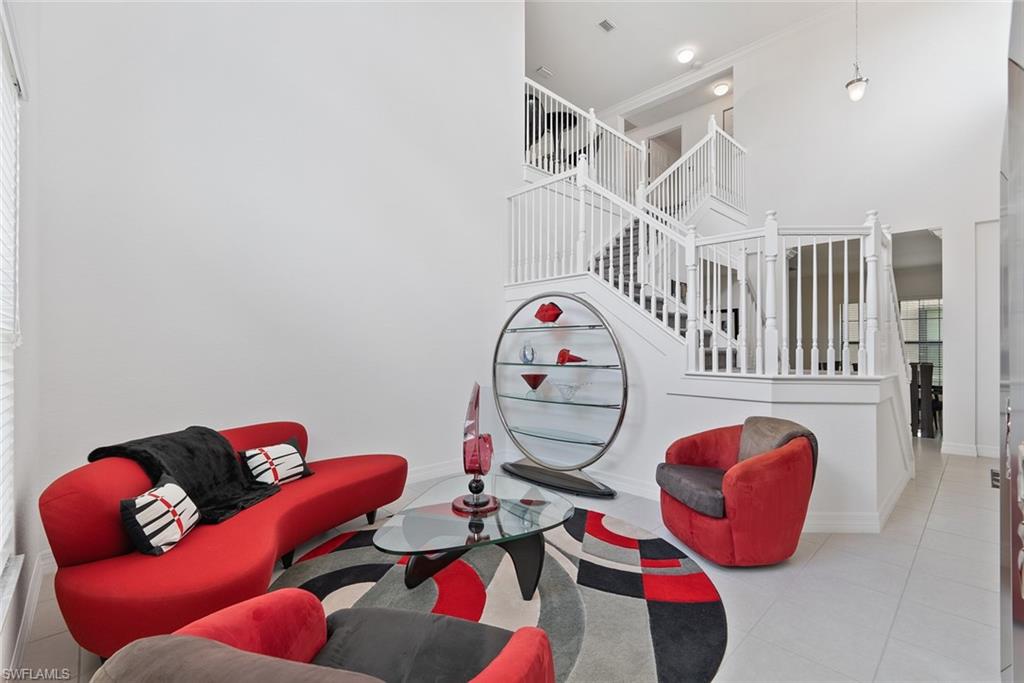 13750 Callisto Avenue Naples, FL 34109 - Photo 16 of 46 a living room with furniture a rug and white walls
