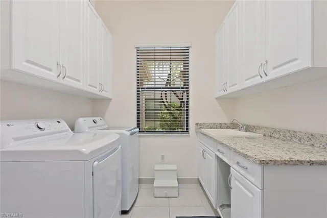 a utility room with a sink washer and dryer