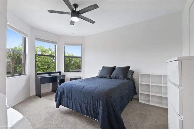 a bedroom with a large bed and a window