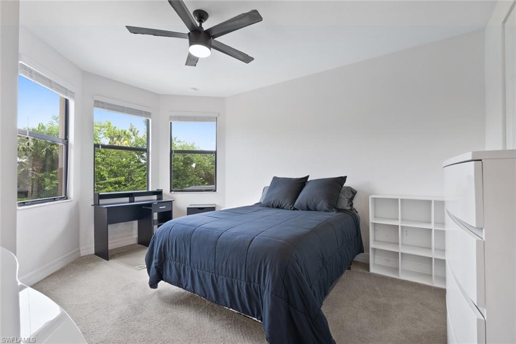13750 Callisto Avenue Naples, FL 34109 - Photo 21 of 46 a bedroom with a large bed and a window
