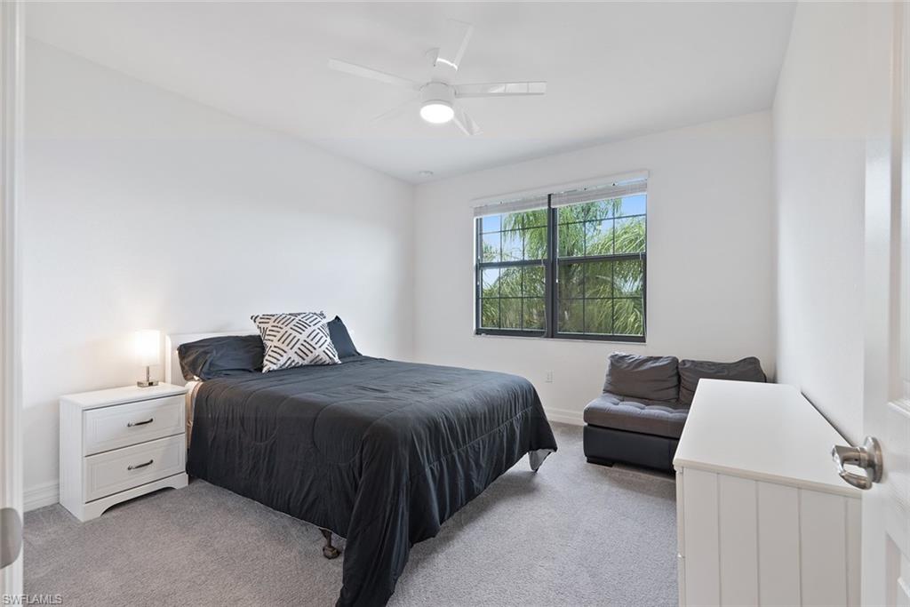 13750 Callisto Avenue Naples, FL 34109 - Photo 22 of 46 a bedroom with a bed and a couch