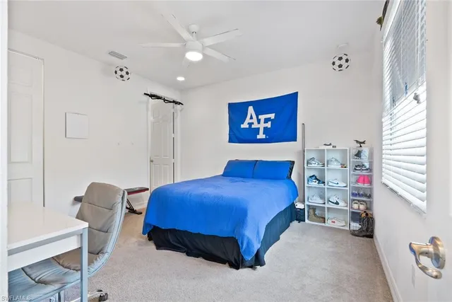 a bedroom with a bed and a workspace