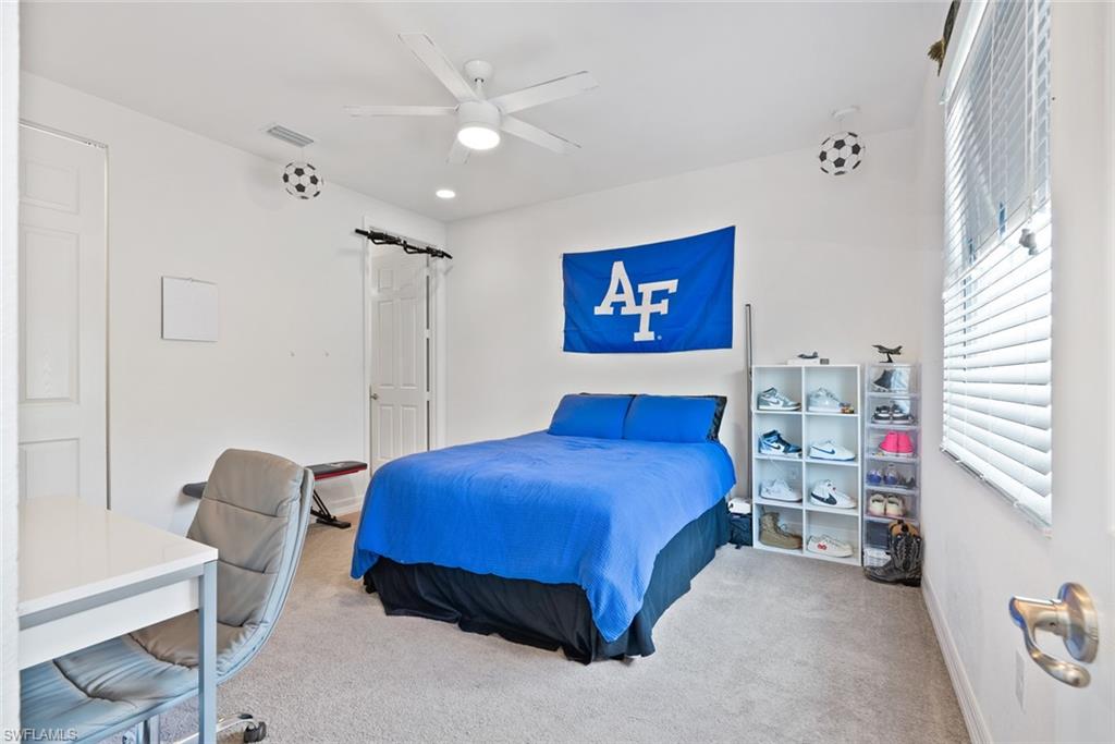 13750 Callisto Avenue Naples, FL 34109 - Photo 24 of 46 a bedroom with a bed and a workspace