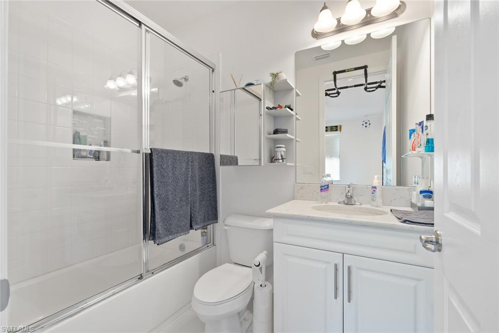 13750 Callisto Avenue Naples, FL 34109 - Photo 25 of 46 a bathroom with a sink a toilet and shower