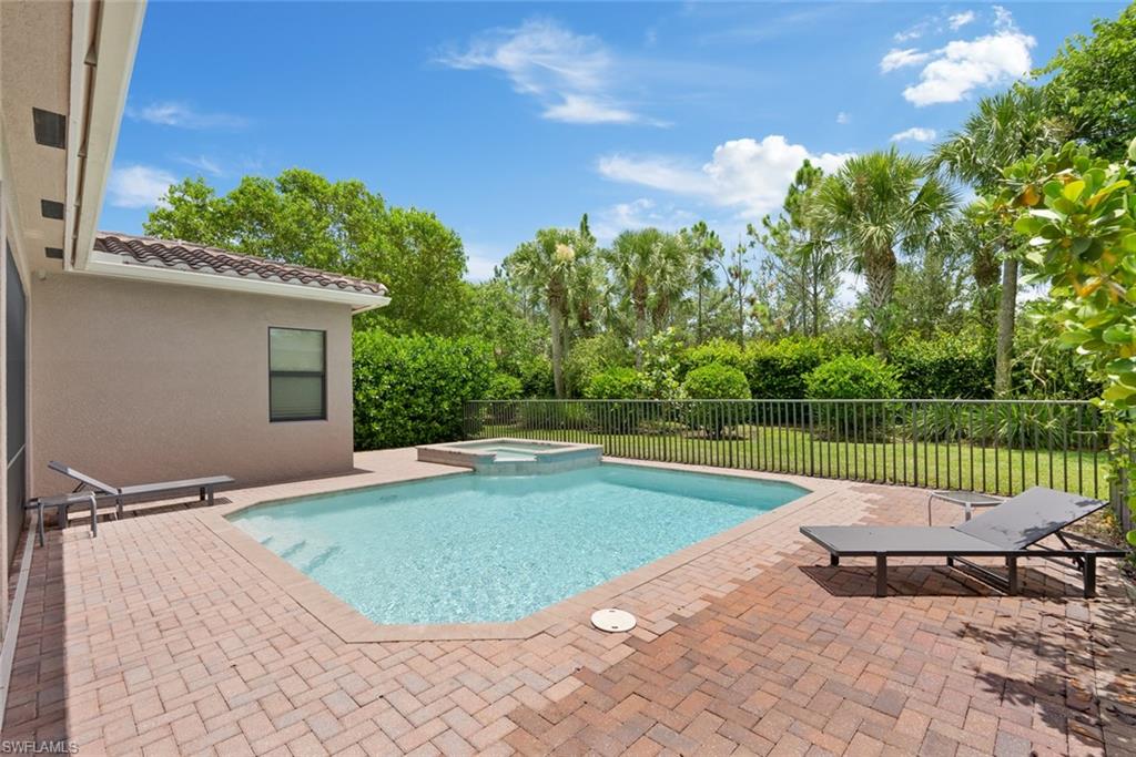 13750 Callisto Avenue Naples, FL 34109 - Photo 27 of 46 a view of a swimming pool with a patio