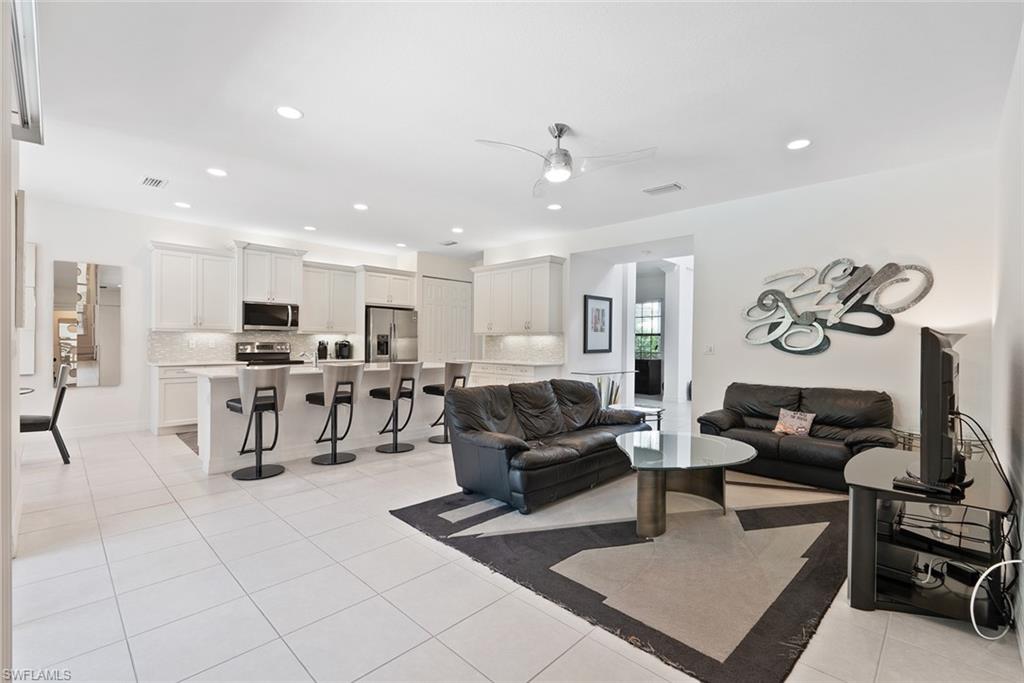 13750 Callisto Avenue Naples, FL 34109 - Photo 9 of 46 a living room with furniture and kitchen view