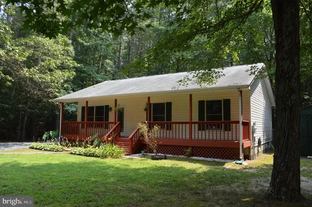 a view of a house with a yard and a garden