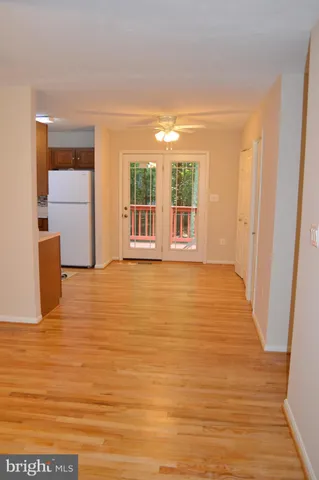 a view of an empty room with window and cabinet