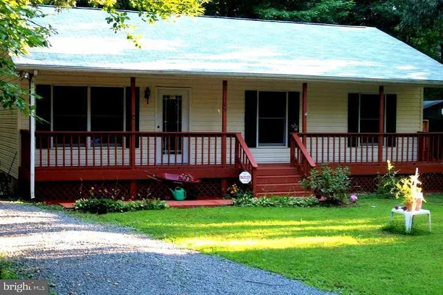 a front view of a house with garden and porch