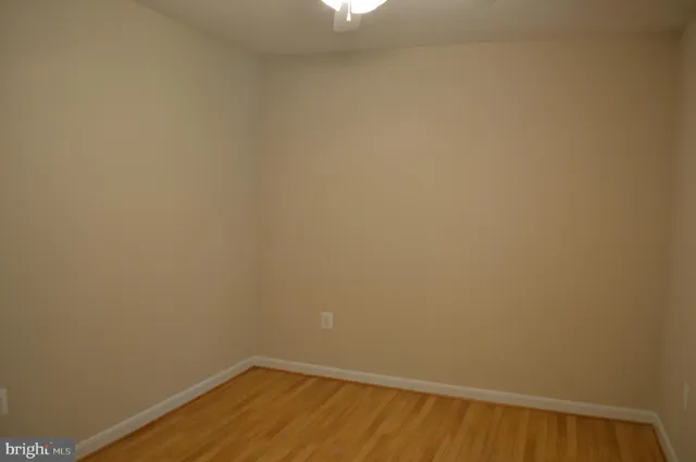 a kitchen with stainless steel appliances granite countertop a sink a stove a refrigerator and cabinets with wooden floor