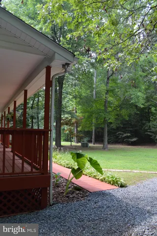 a view of a backyard with table and chairs under an umbrella