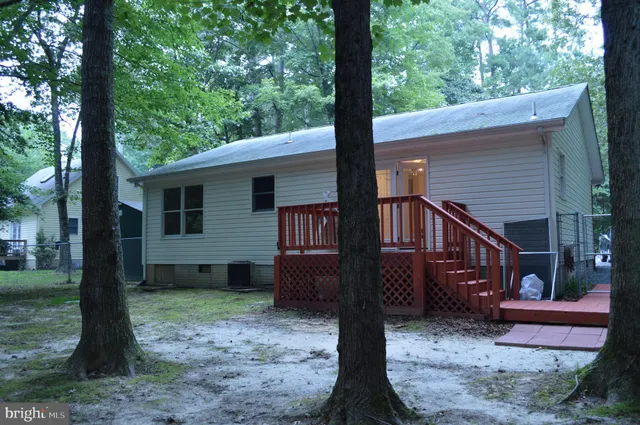 a view of a house with a yard balcony and a tree