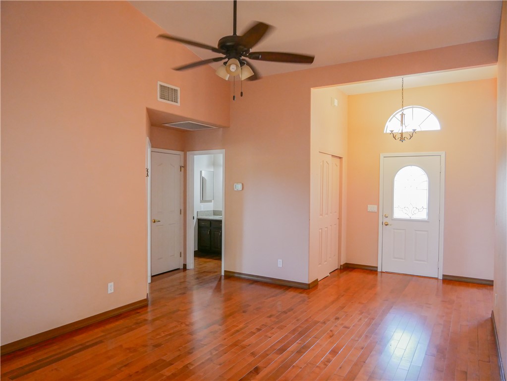 2575 Triangle S Street Kingman, AZ 86401 - Photo 18 of 45 wooden floor in an empty room with a window