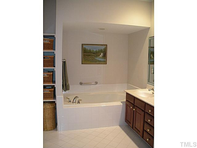 7414 Fontana Ridge Lane Raleigh, NC 27613 - Photo 25 of 25 Large soaking tub in addition to a walk in shower. Don't miss the extra storage behind the door. Master Bath/Spa