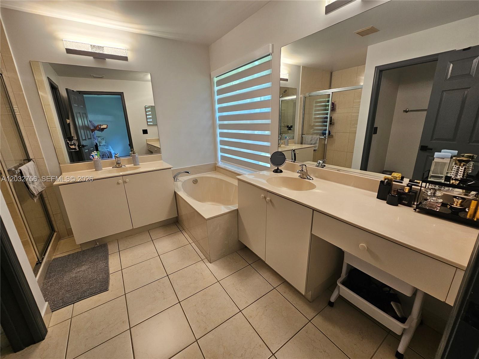 4331 Southwest 124th Way Miramar, FL 33027 - Photo 13 of 40 a bathroom with a sink a mirror and a bathtub