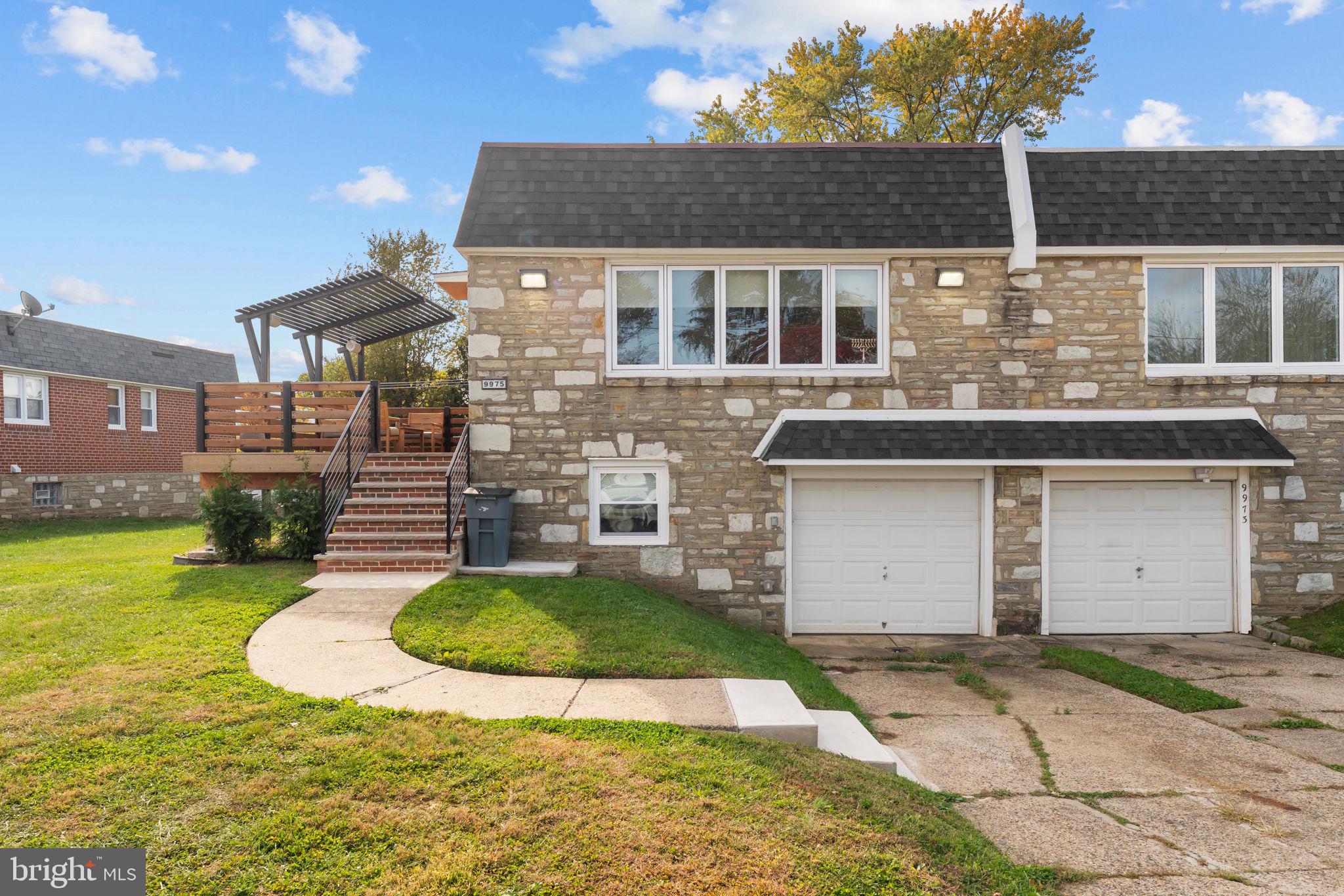 9975 Woodfern Road Philadelphia, PA 19115 - Photo 1 of 35 a view of a white house with a yard and outdoor space