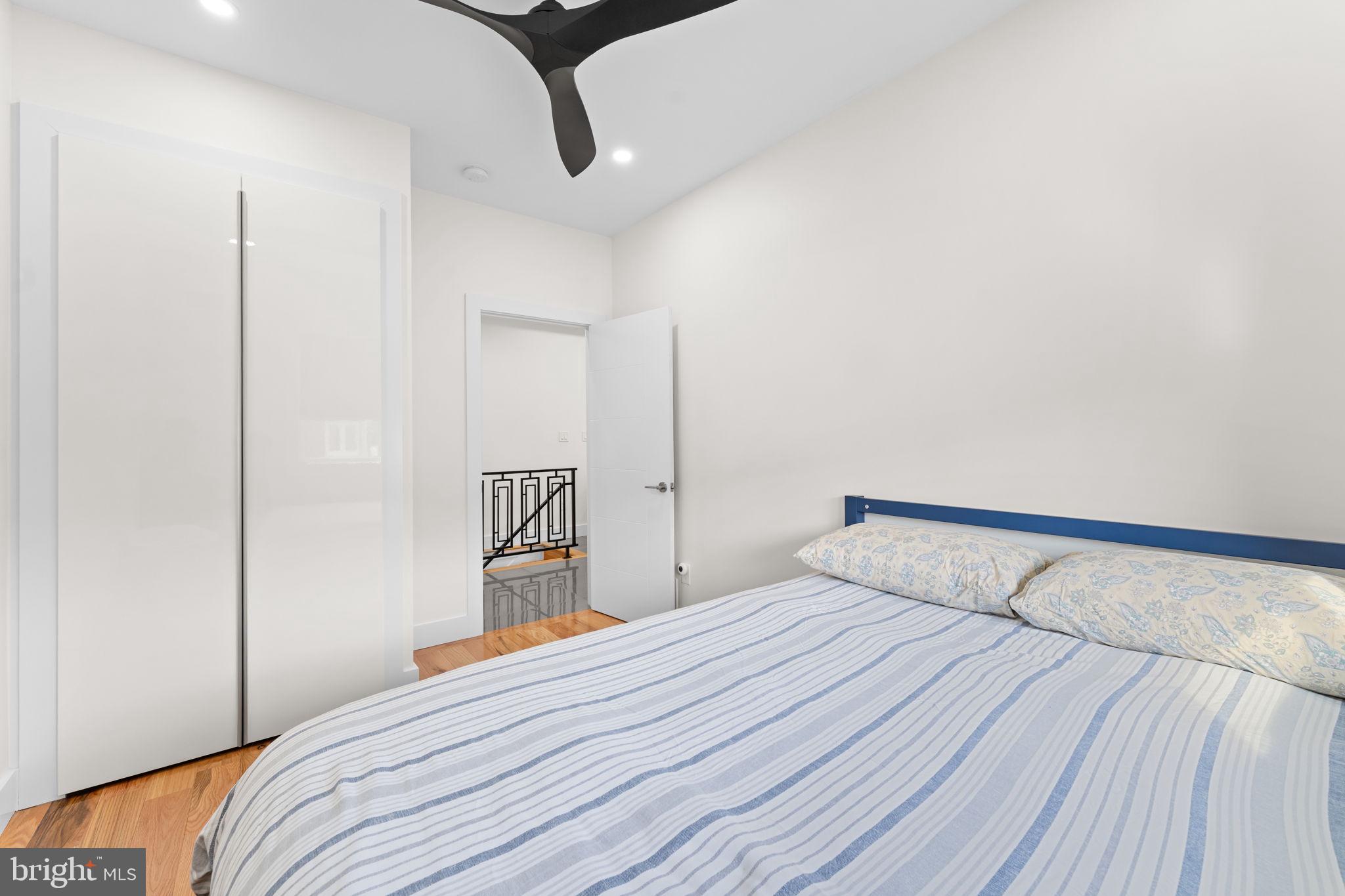 9975 Woodfern Road Philadelphia, PA 19115 - Photo 21 of 35 a bedroom with a bed and wooden floor