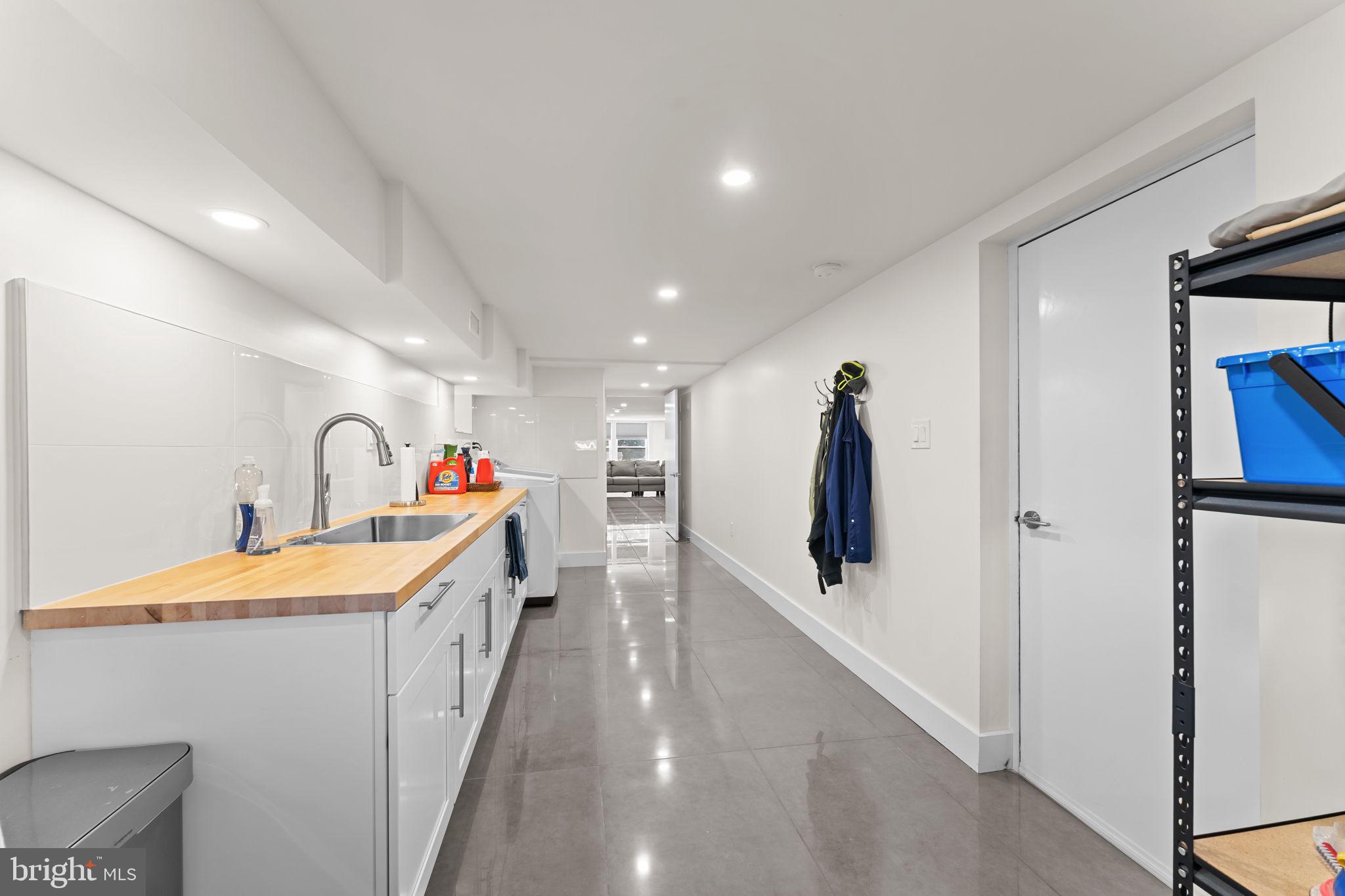 9975 Woodfern Road Philadelphia, PA 19115 - Photo 31 of 35 a hallway with a sink and mirror