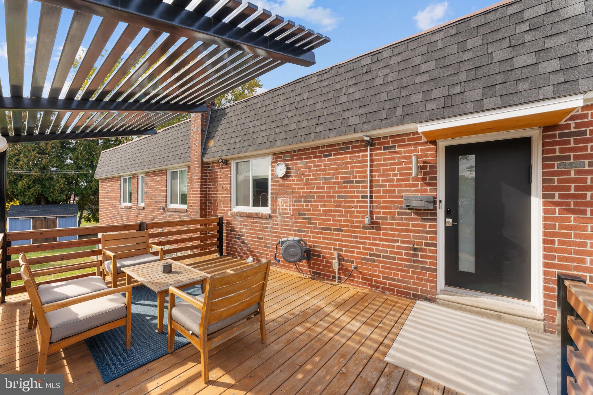 9975 Woodfern Road Philadelphia, PA 19115 - Photo 5 of 35 a backyard of a house with wooden seating space