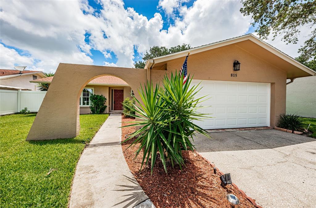815 Kirkland Circle Dunedin, FL 34698 - Photo 1 of 1 a front view of house with yard and trees around