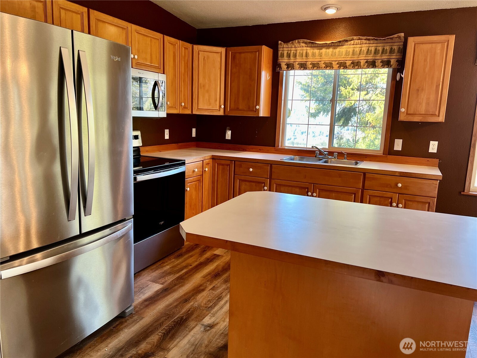 4084 Deep Lake Boundary Road Colville, WA 99114 - Photo 11 of 40 a kitchen with stainless steel appliances a refrigerator sink and cabinets