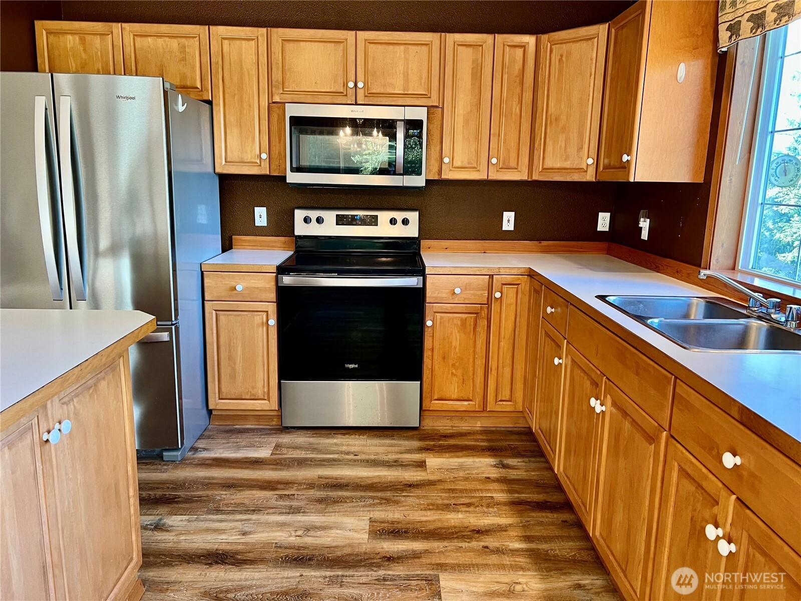 4084 Deep Lake Boundary Road Colville, WA 99114 - Photo 12 of 40 a kitchen with stainless steel appliances granite countertop a refrigerator a stove a sink and a microwave