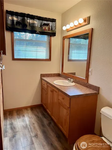 a bathroom with a sink a toilet and mirror