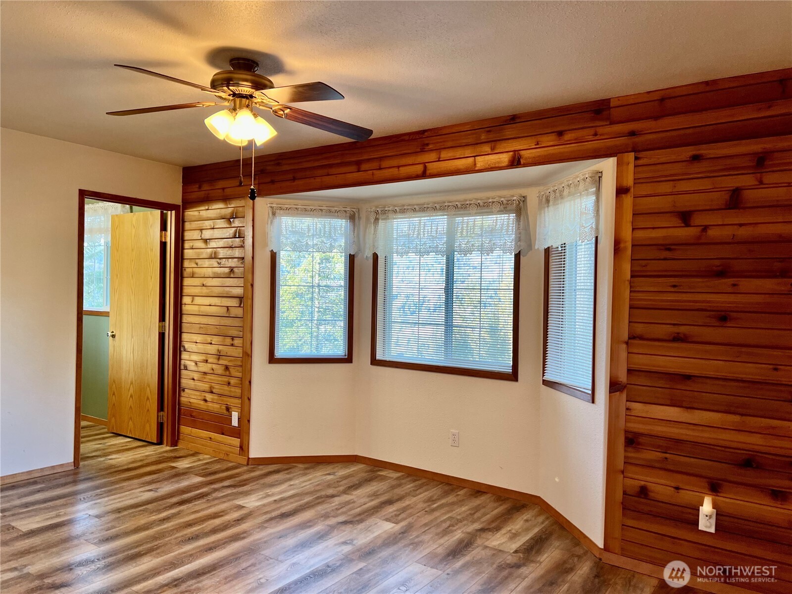 4084 Deep Lake Boundary Road Colville, WA 99114 - Photo 7 of 40 a view of an empty room with a window and wooden floor