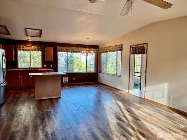 a living room with hardwood floor and a large window