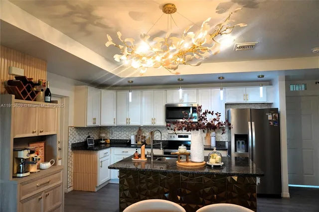 a kitchen with a refrigerator and a stove top oven