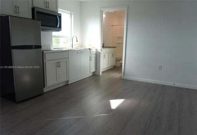 a kitchen with a refrigerator and a sink