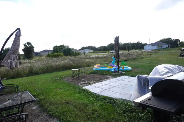 a view of a table and chairs in the garden