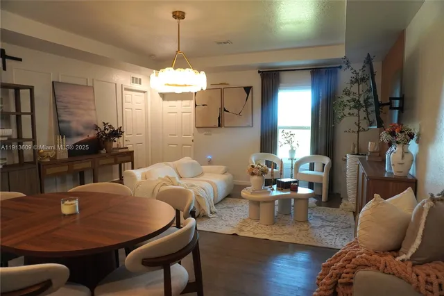 a view of a dining room with furniture window and wooden floor