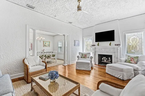 a living room with furniture a fireplace and a flat screen tv