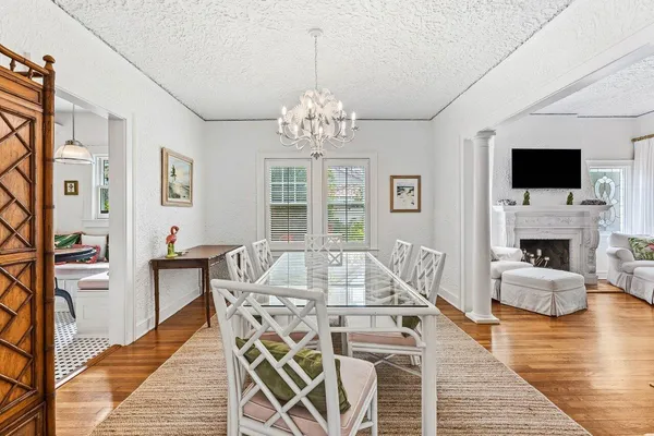 a view of a livingroom with furniture a flat screen tv and wooden floor
